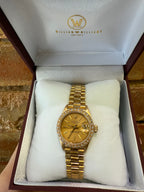 Gold ladies Rolex watch in a branded box