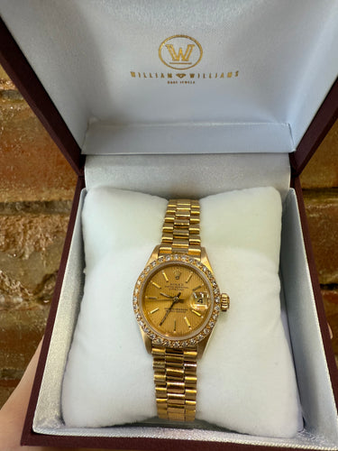 Gold ladies Rolex watch in a branded box