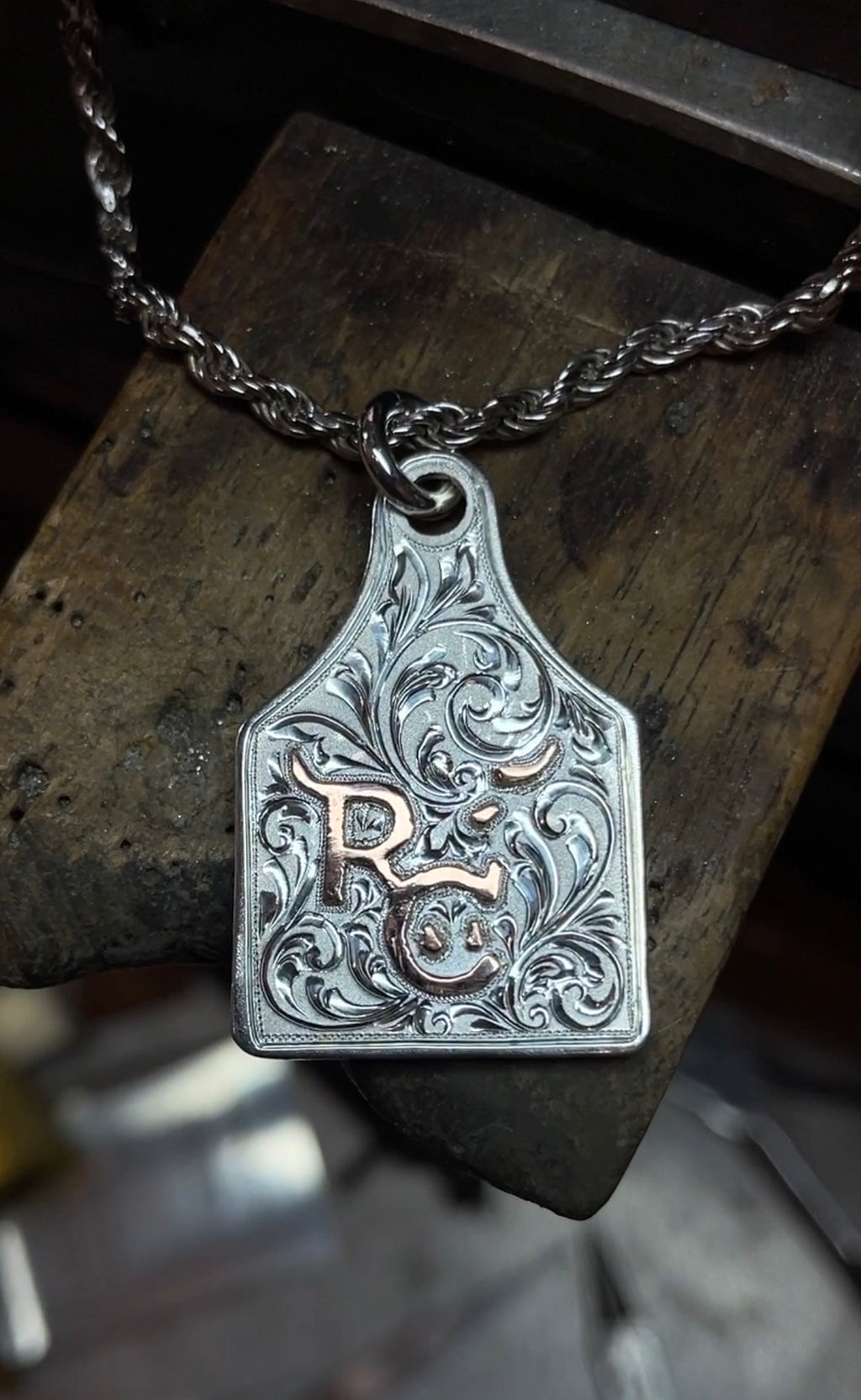Rodeo Celina Silver necklace with a detailed pendant on a wooden surface