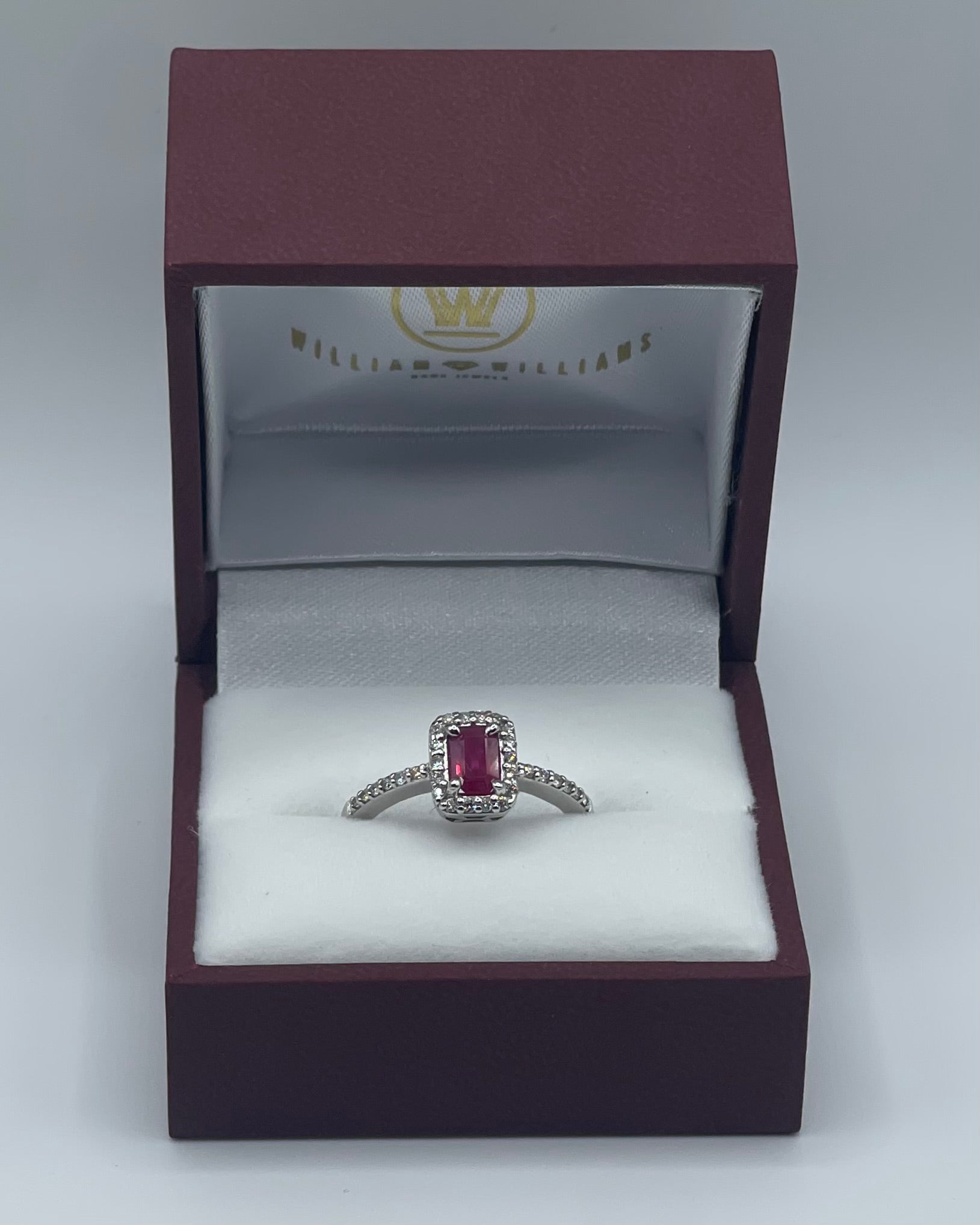 Exquisite 14k White Gold 0.75ct Emerald-Cut Ruby and 0.25ctw Diamond Halo Ring