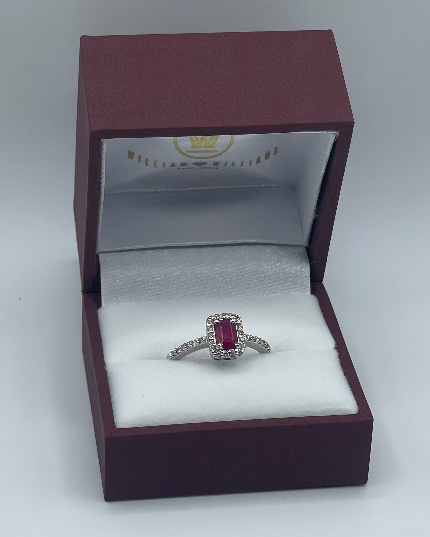 Exquisite 14k White Gold 0.75ct Emerald-Cut Ruby and 0.25ctw Diamond Halo Ring