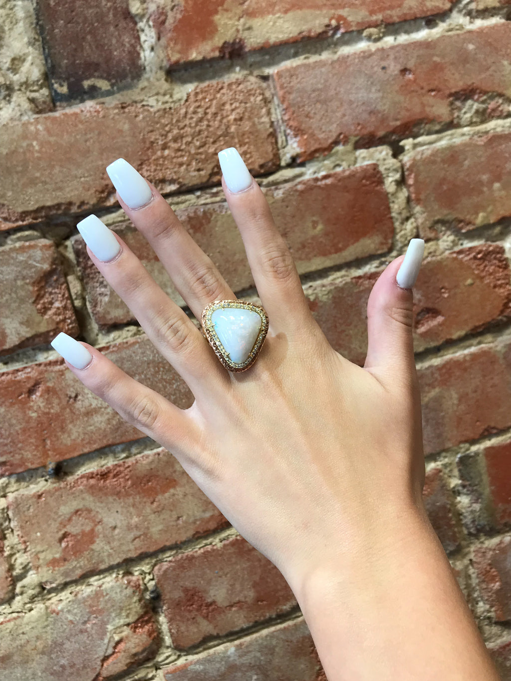 18K Yellow & Rose Gold 21.34ct. Australian Opal 0.80tcw. Diamond Ring Size 6.25 on hand in front of brick wall